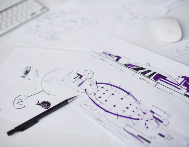 Image of sketches and pen at workplace